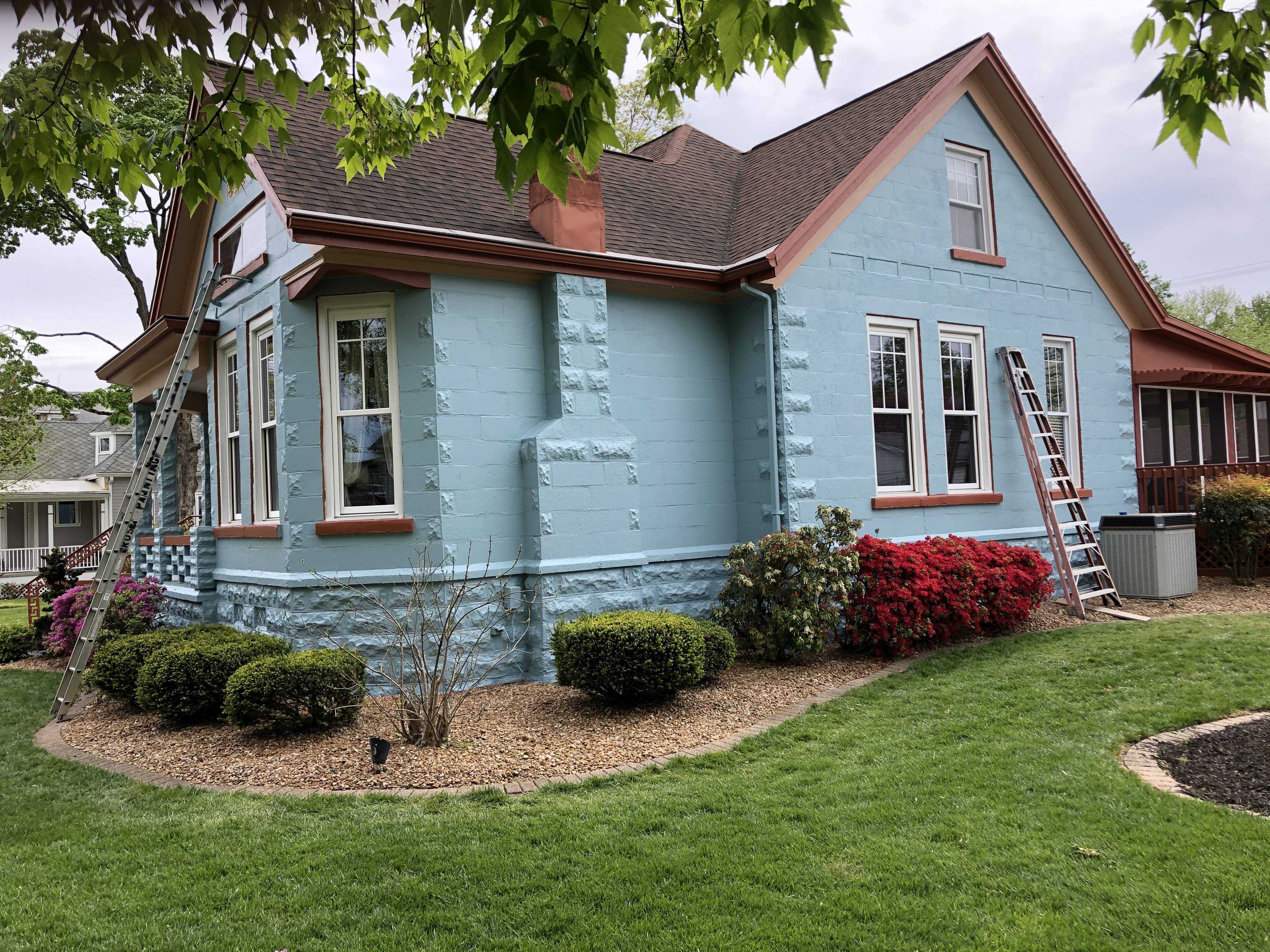 Rose Painting crew member painting exterior trim